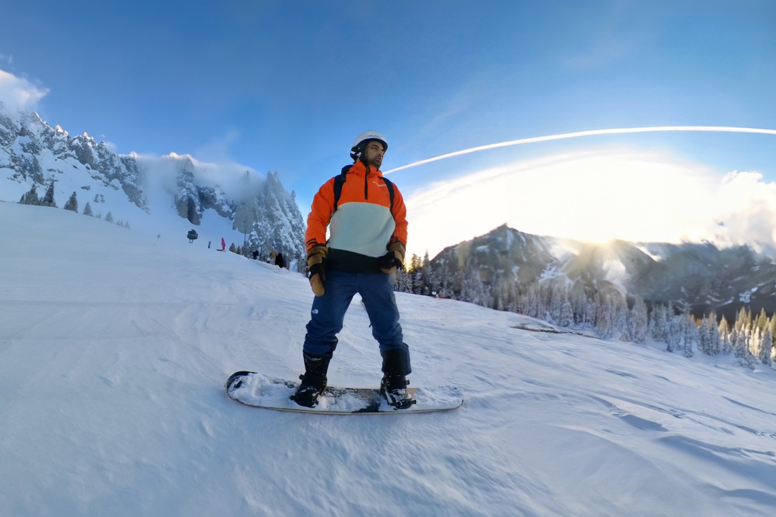 Web designer snowboarding on mountain